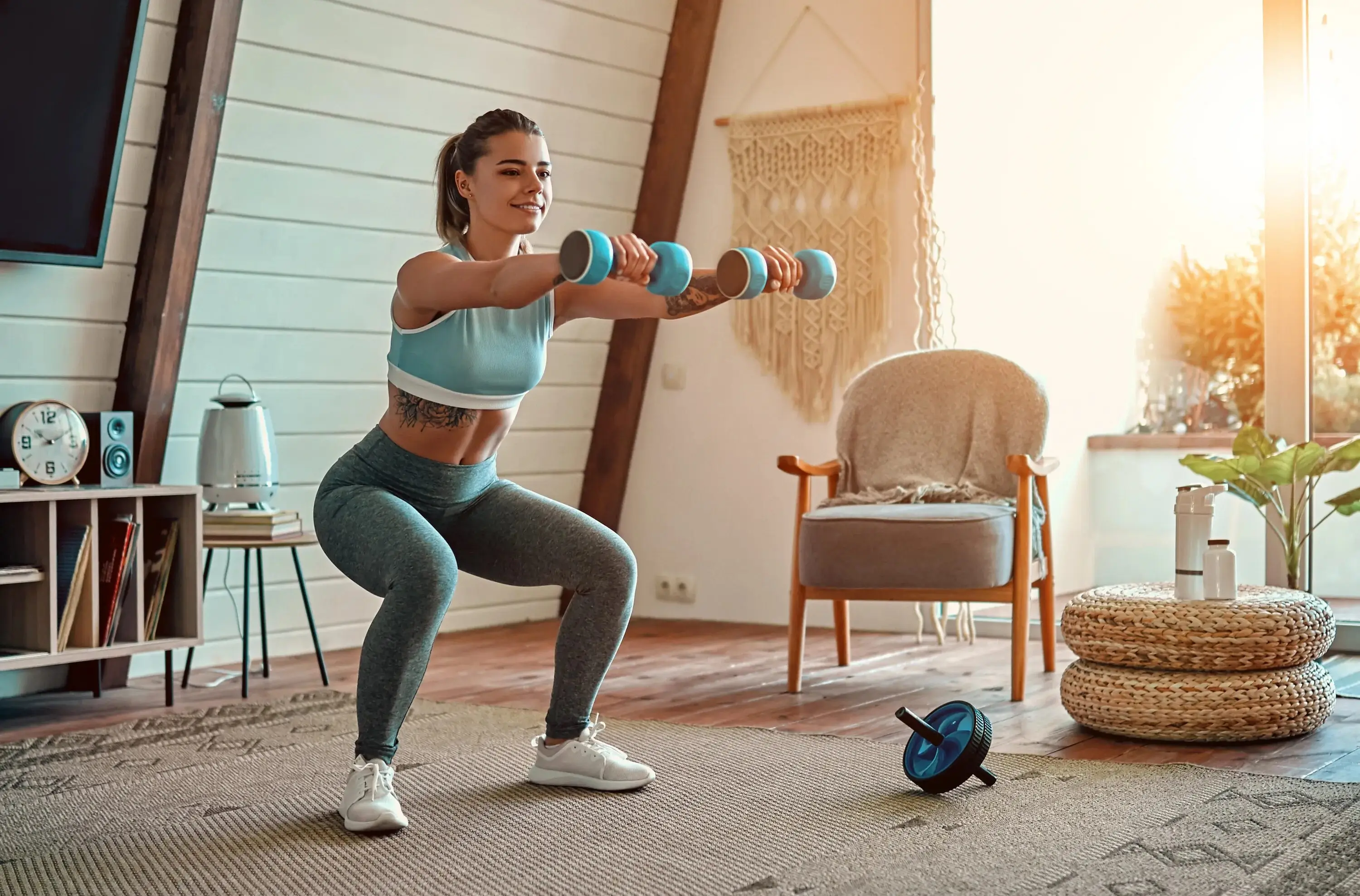 Woman working out at home with dumbbells