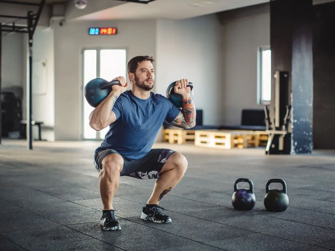 Man lifting a kettlebell in a focused workout
